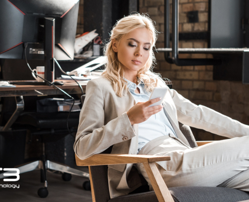 business woman checking phone while sitting